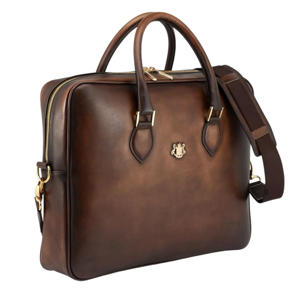 Luxury brown leather briefcase with top handles and detachable shoulder strap on a white background.