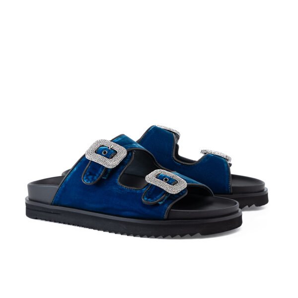 Electric Blue Ariana blue velvet slide sandal with crystal buckles and black serrated sole.