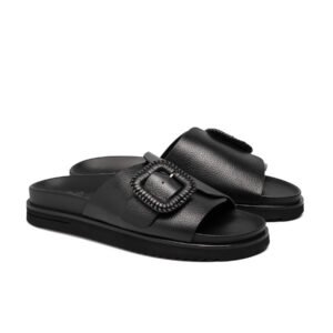 Nicholas black pebbled leather slides featuring a statement buckle and chunky ridged sole.